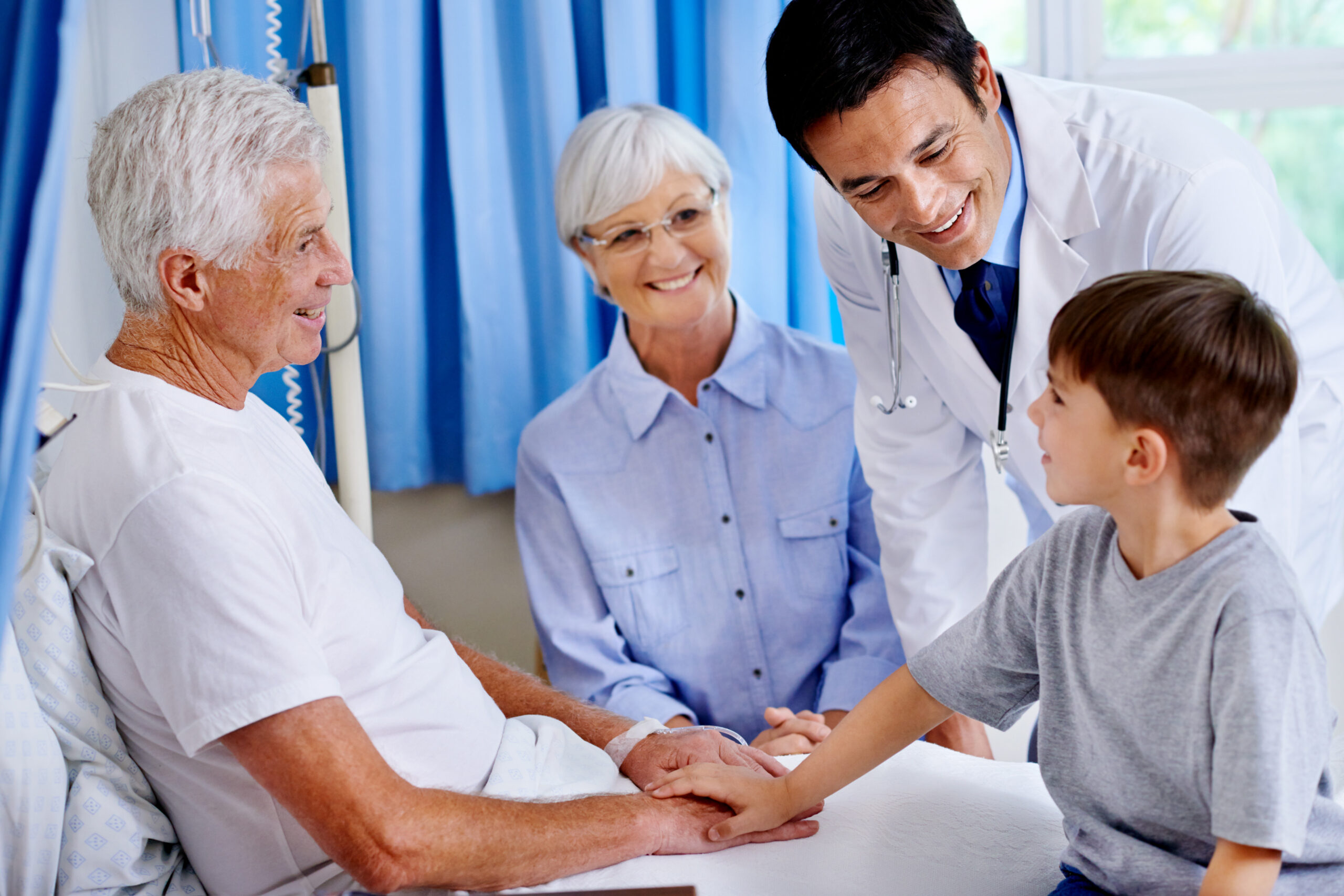 Grandfather, child and support in clinic with doctor for healing, rehabilitation or medical healthcare with family. Grandpa, boy or holding hands for comfort, recovery or good news for happy patient.